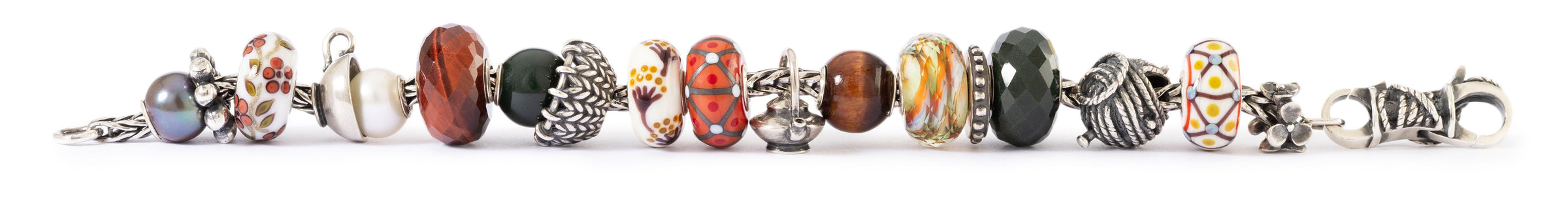 Bracelet with various beads in warm colours on a white background