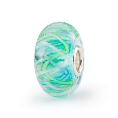 Inside the glass bead thin stripes of pale green, white and light blue formed in a criss-cross pattern.